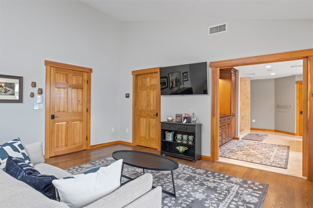 Second floor master bedroom ensuite with king bed and couch and its own bathroom
