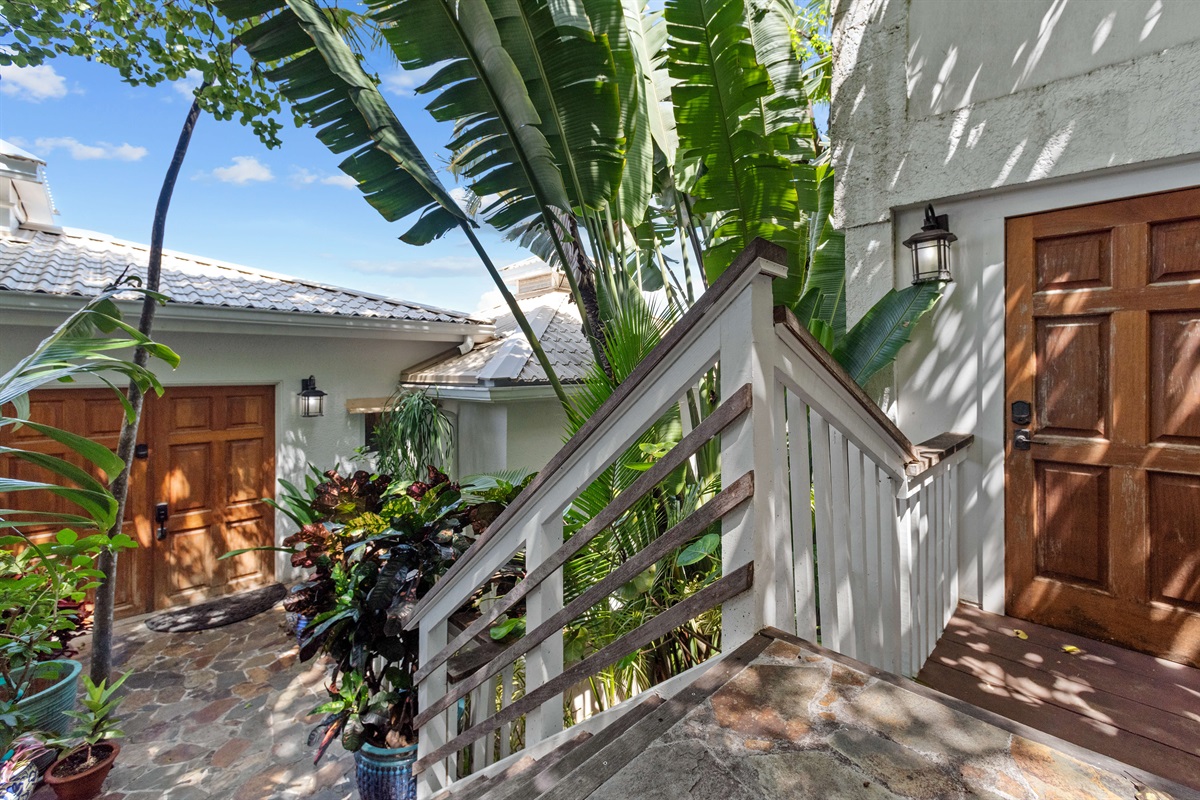 The front double doors lead you to the villa, and the door on the right is the cottage entry.