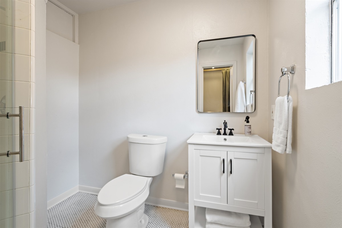 Detached Studio private full bathroom with walk-in shower and vanity. Stocked with Ginger Lily Farms shampoo, conditioner, and shower gel. Fresh towels, hairdryer, and essentials provided.