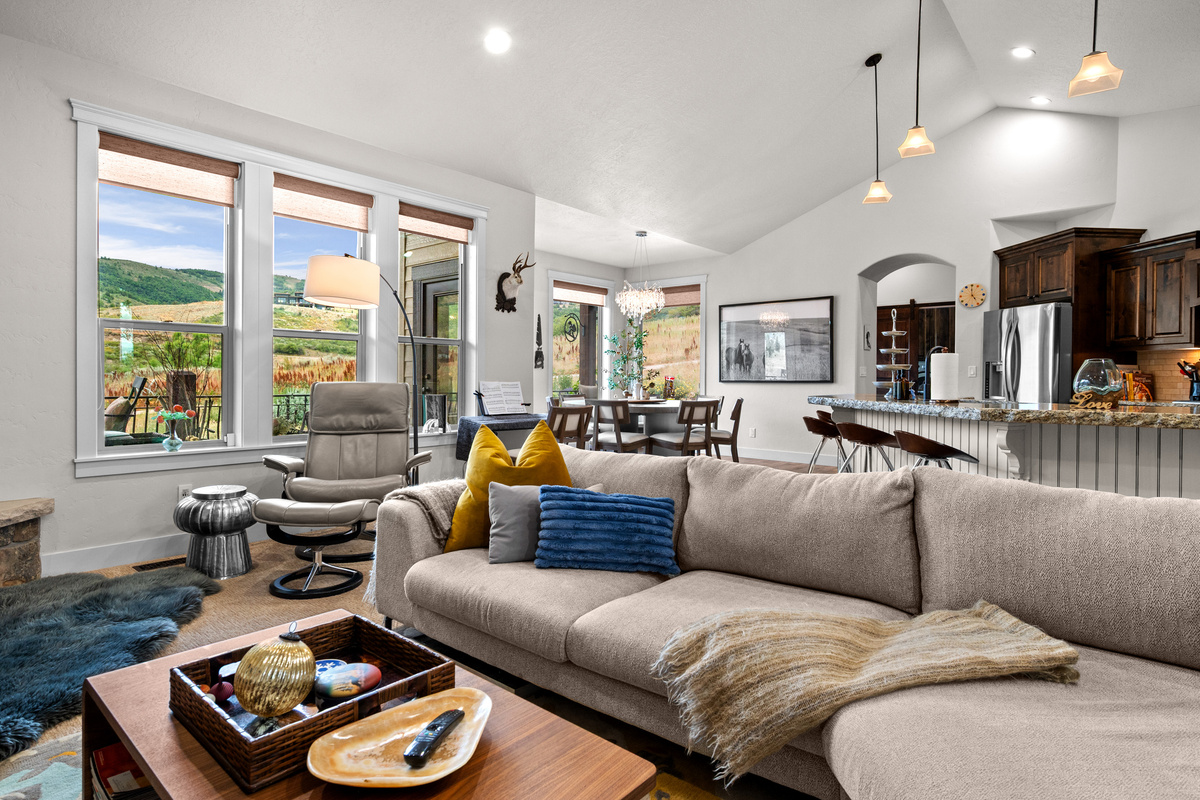 Bright, Open Living with Scenic Views – Floor-to-ceiling windows fill the great room with natural light while showcasing beautiful mountain views. The open-concept design seamlessly connects the living area, dining space, and gourmet kitchen, making it ide