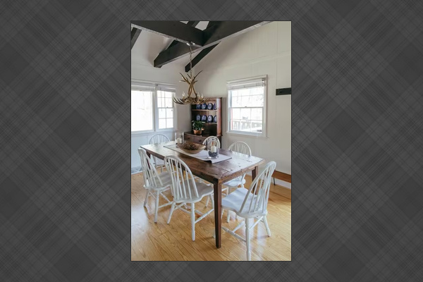 Gather around the farmhouse table beneath reclaimed beams and antler chandeliers.