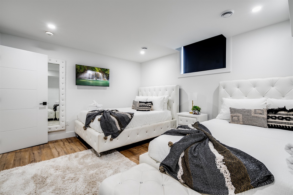 Lower level bedroom with two queen beds.