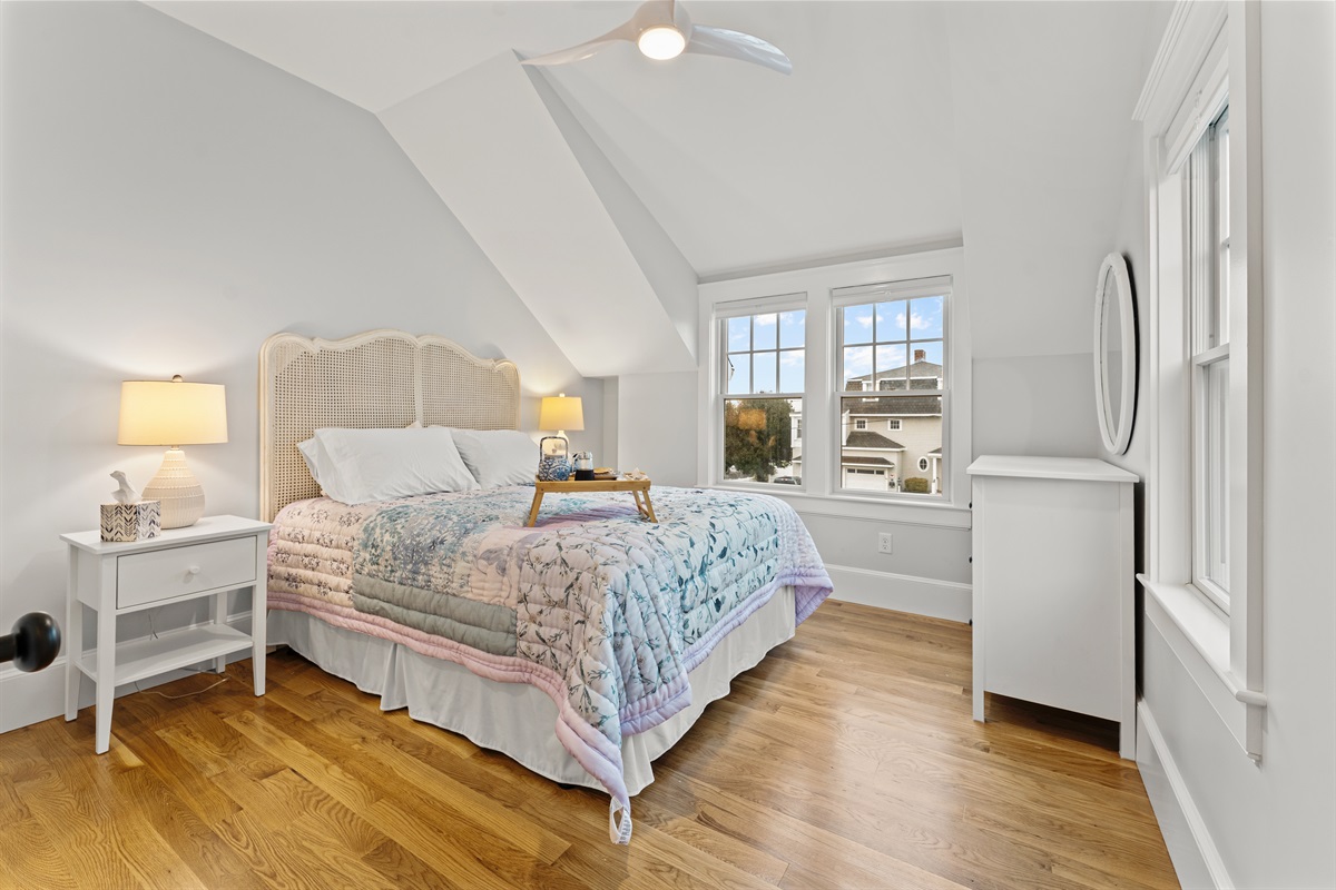 Enjoy natural light and cozy comforts in the first bedroom.
