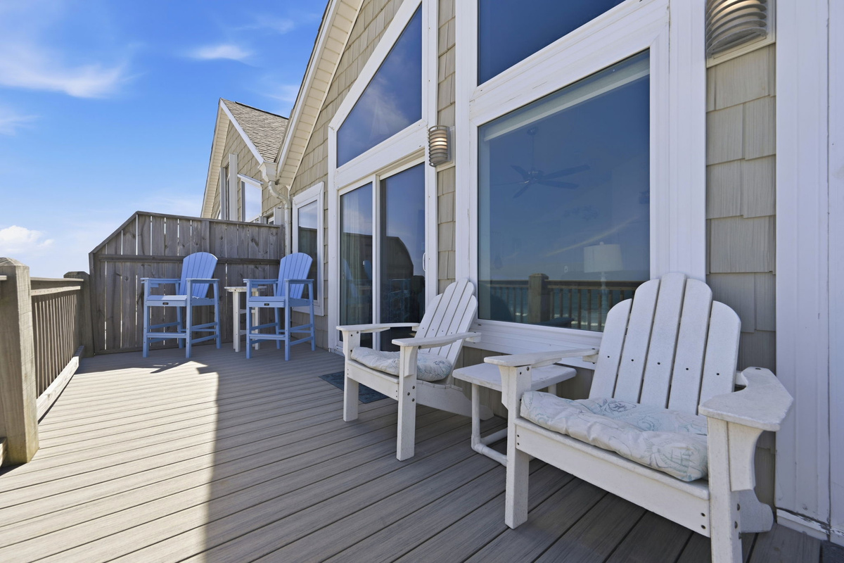 Spacious oceanfront deck with bar seating and seamless indoor outdoor flow