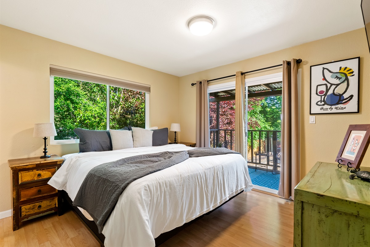A cozy, airy bedroom with private deck access for morning coffee.