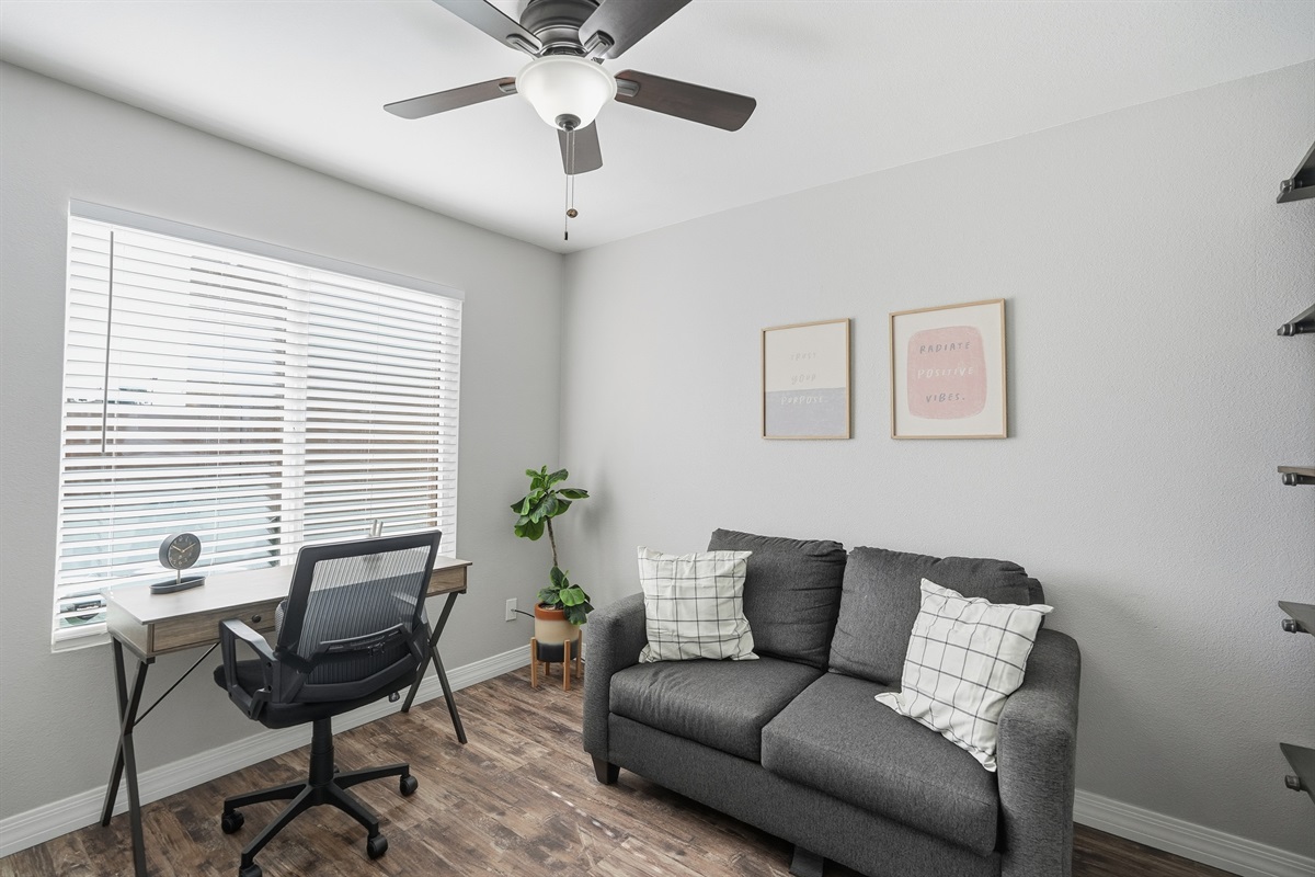 Versatile office-bedroom with workspace and comfy pullout sofa for productive, relaxing stays