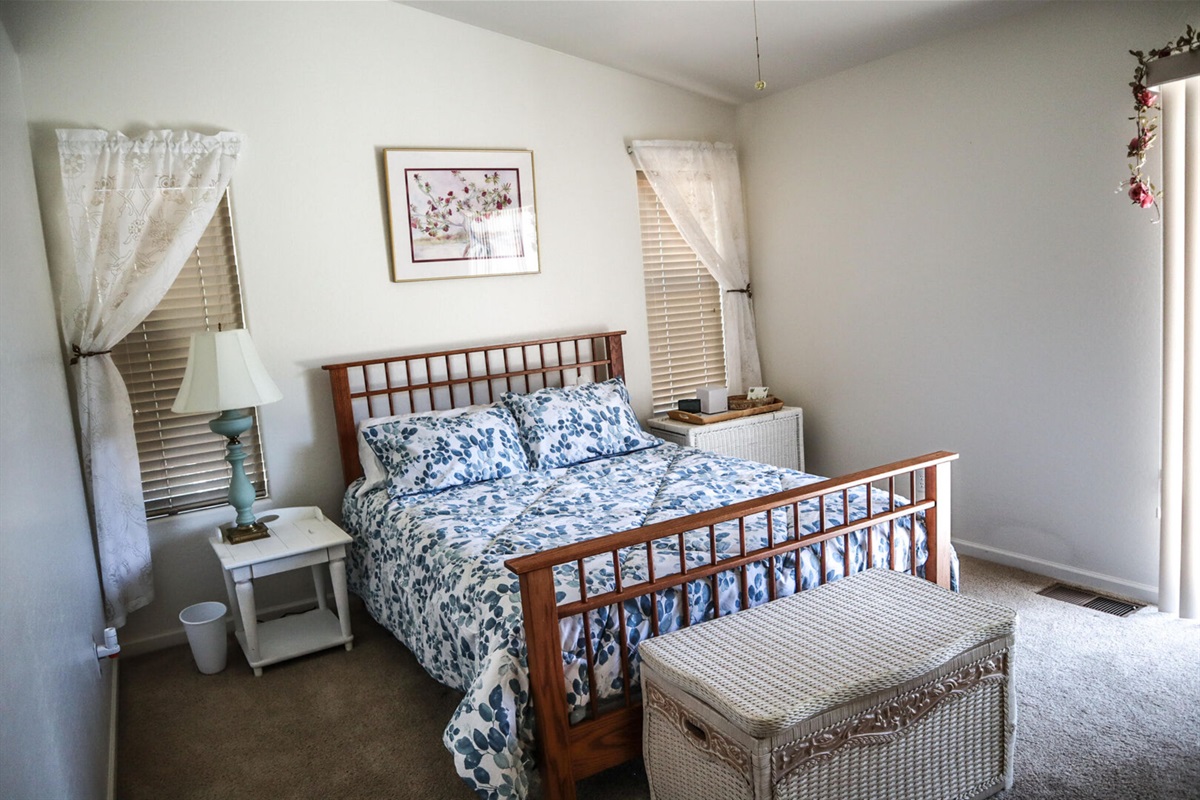 Bedroom 2 offers a queen size bed and ceiling fan.