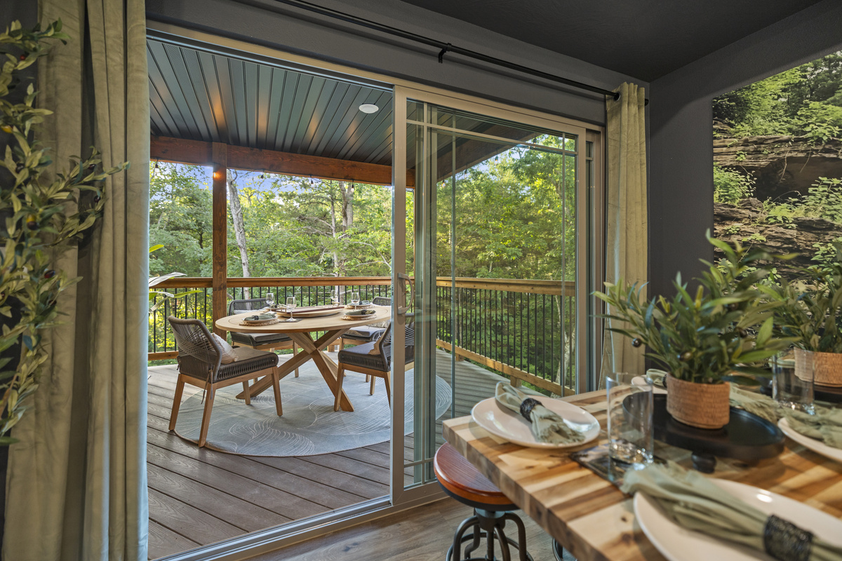 A round bistro table by the screened windows for a quiet morning coffee.