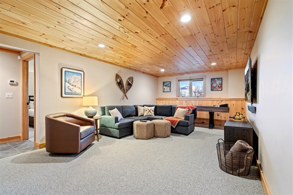 Get comfy and enjoy endless entertainment in the basement living room.