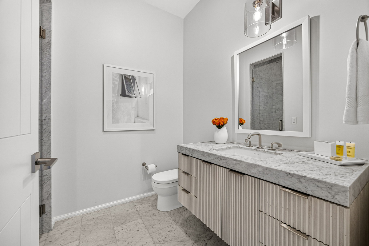 Guest Suite #2 ensuite bath offers an oversized vanity and walk-in shower.