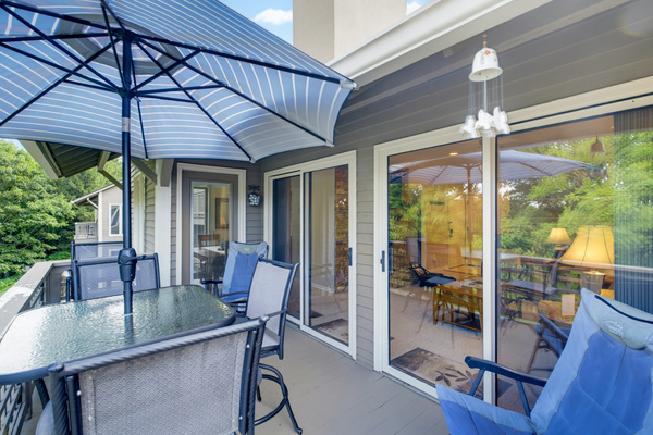 Double sliding doors open from the living room to the deck.