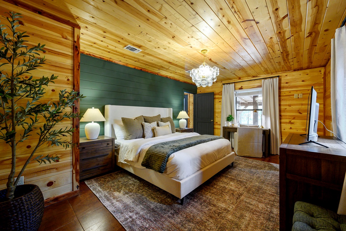 A private bedroom retreat featuring a comfortable bed and calming design. The perfect place to recharge after a day exploring Broken Bow.