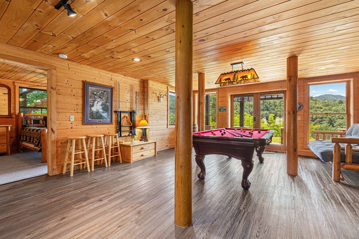 Downstairs Game Room: Unwind in style with a pool table, mountain views, and rustic charm!