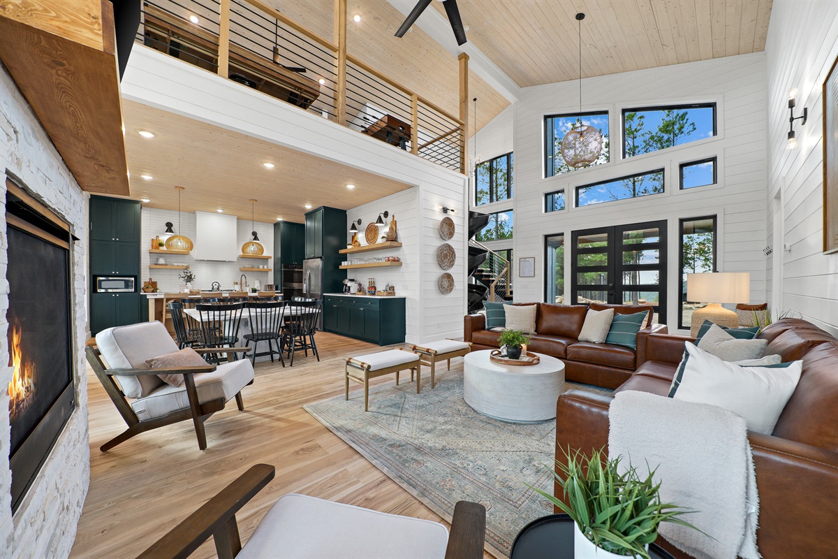 Soaring ceilings, gorgeous large windows and thoughtfully curated furnishings and decor are the perfect blend for a bright and open yet inviting and cozy space!