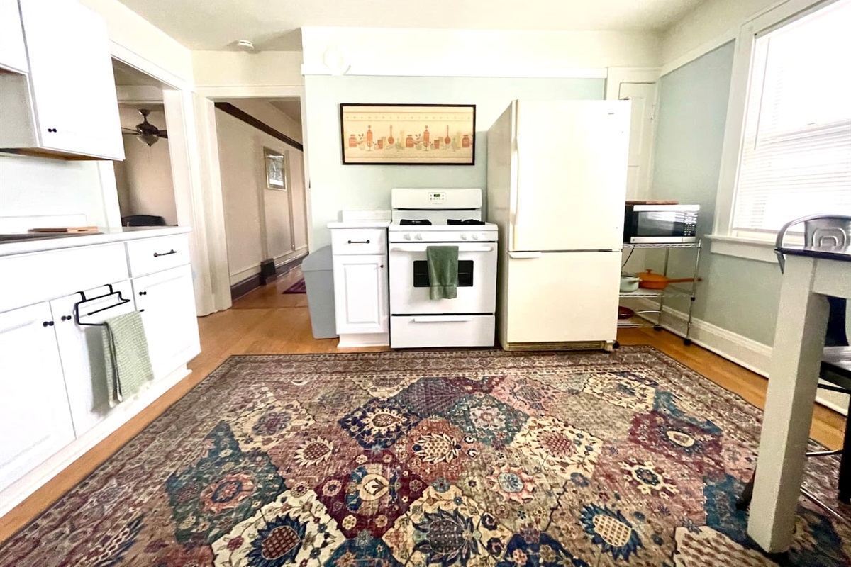 Full kitchen with gas stove, refrigerator, and space to prepare and enjoy meals.