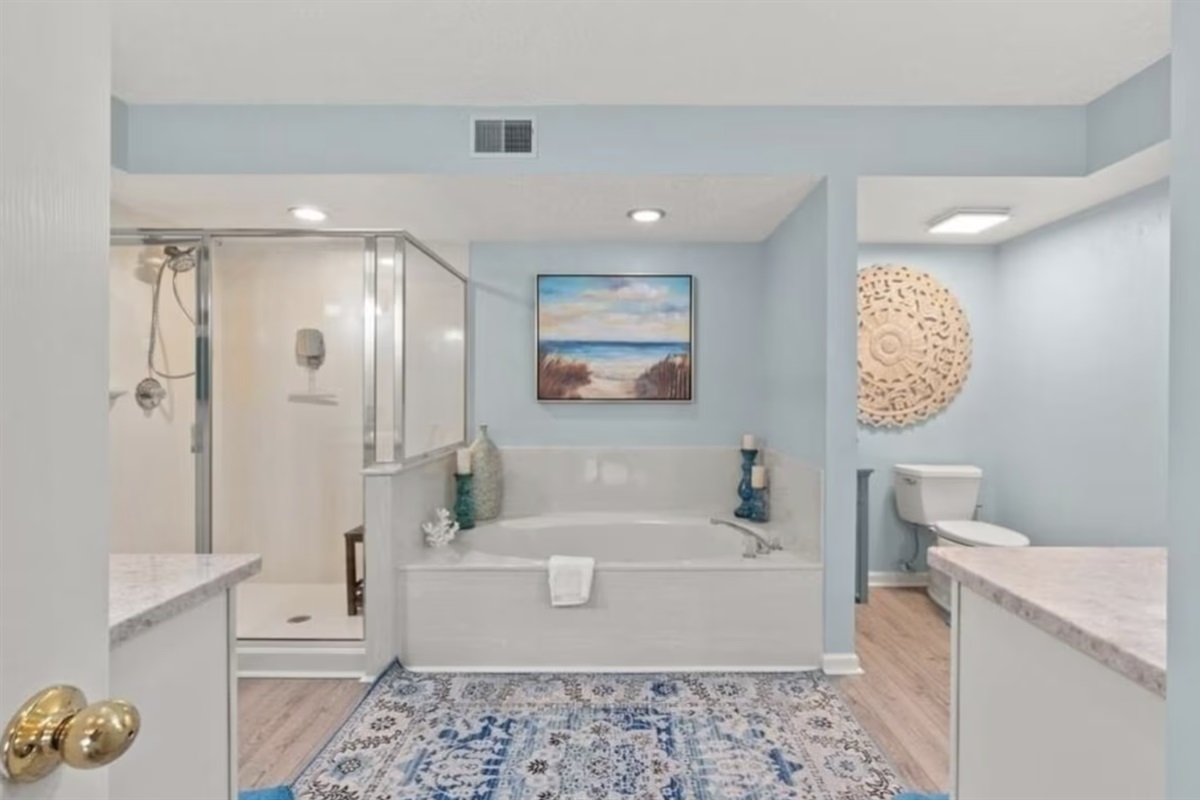 The primary ensuite bathroom has a large step-in shower, a jacuzzi tub, and 2 separate sinks and counterspaces.