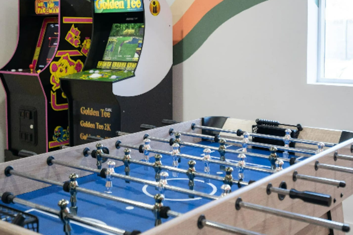 Foosball and vintage arcade cabinets side by side mean there's always another game to play.