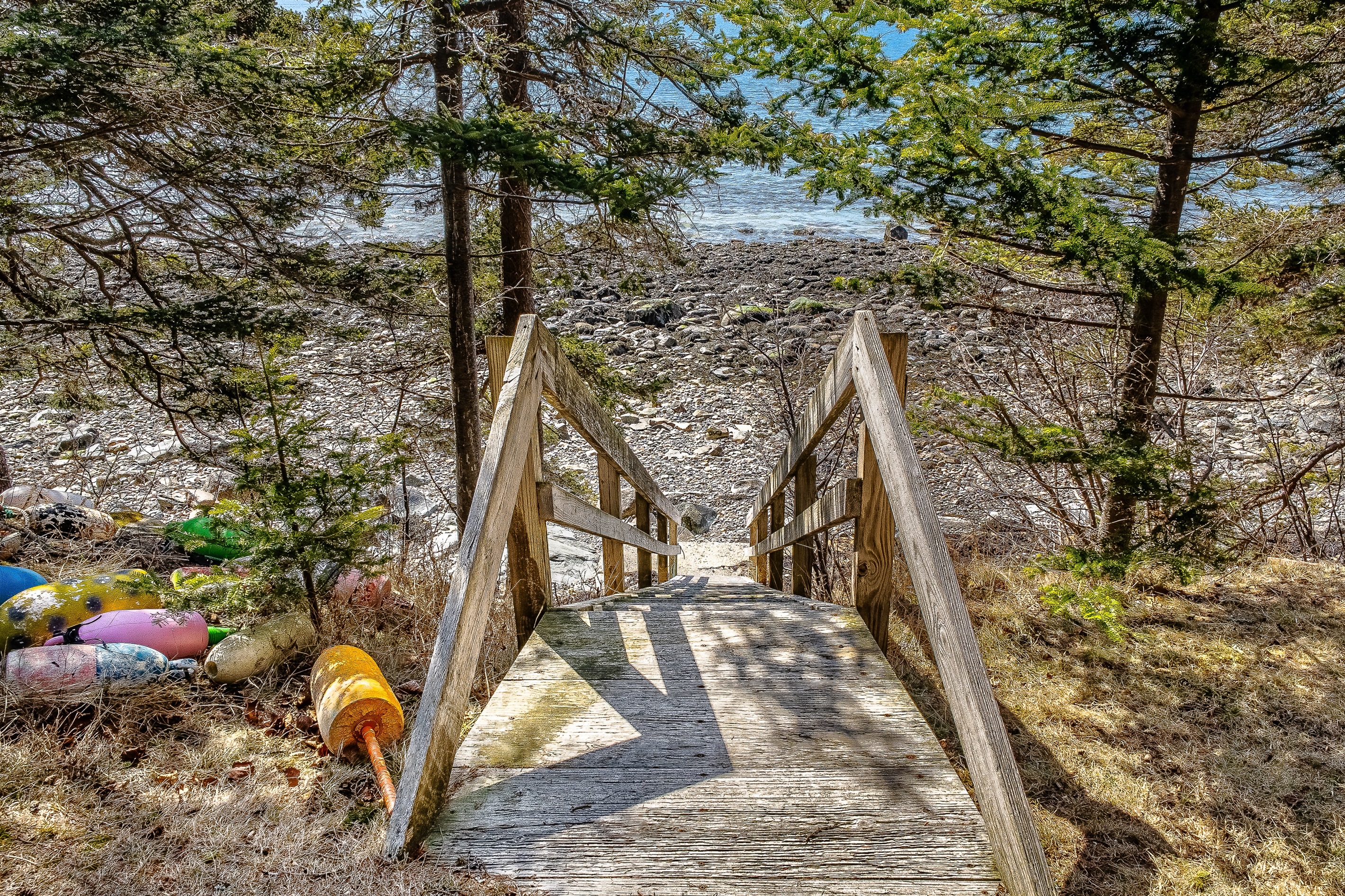 "Private Access to the Coast."
A private, rugged staircase leads directly from the yard to the Bass Harbor shoreline. At low tide, the rocky beach becomes your personal highway for beachcombing and tidal exploration.