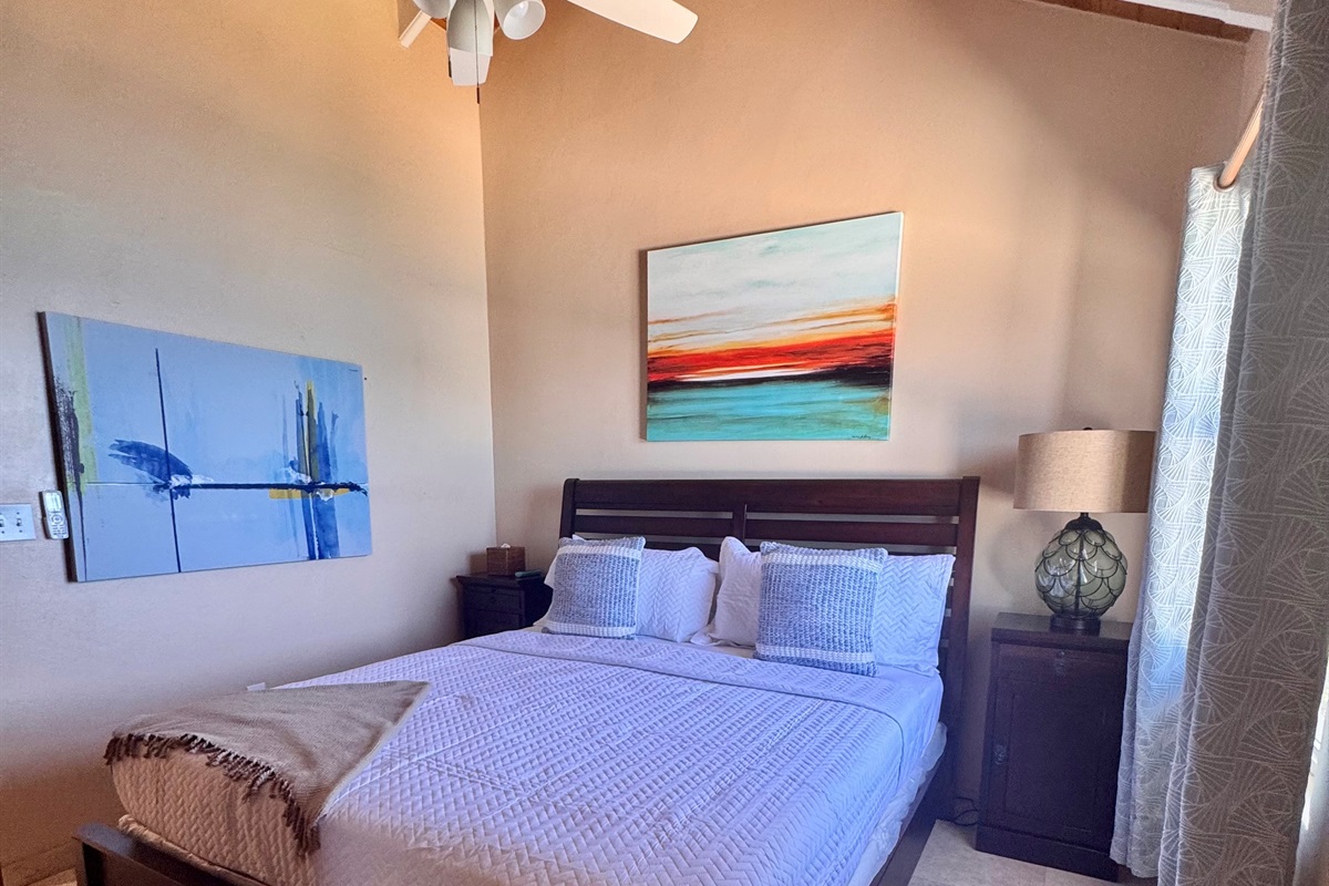 Suite two with king bed -  A/C and calming décor—quiet, cool, and restful after beach days.