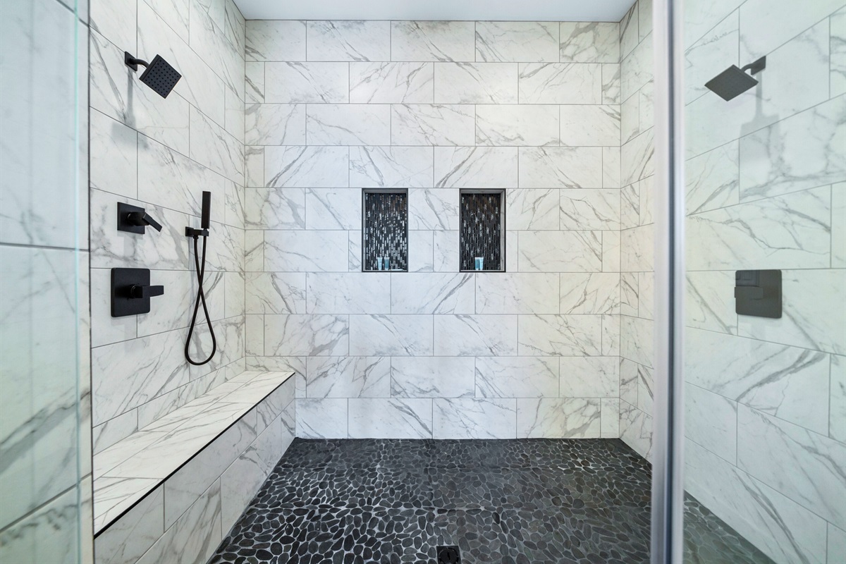 Step into luxury with this beautifully tiled walk-in shower, complete with modern fixtures and a serene ambiance to elevate your daily routine.