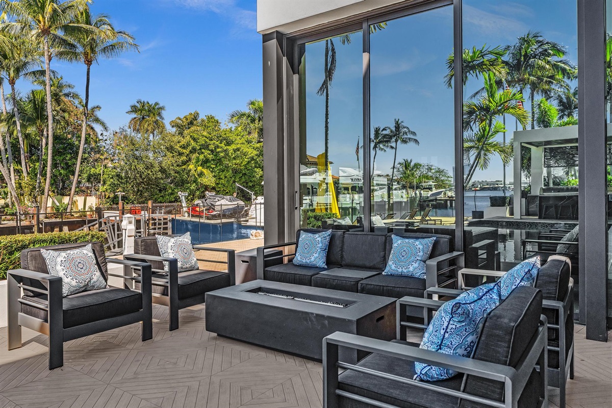 Cozy fire pit lounge overlooking the water — an inviting setting for sunset cocktails and late-night conversations.