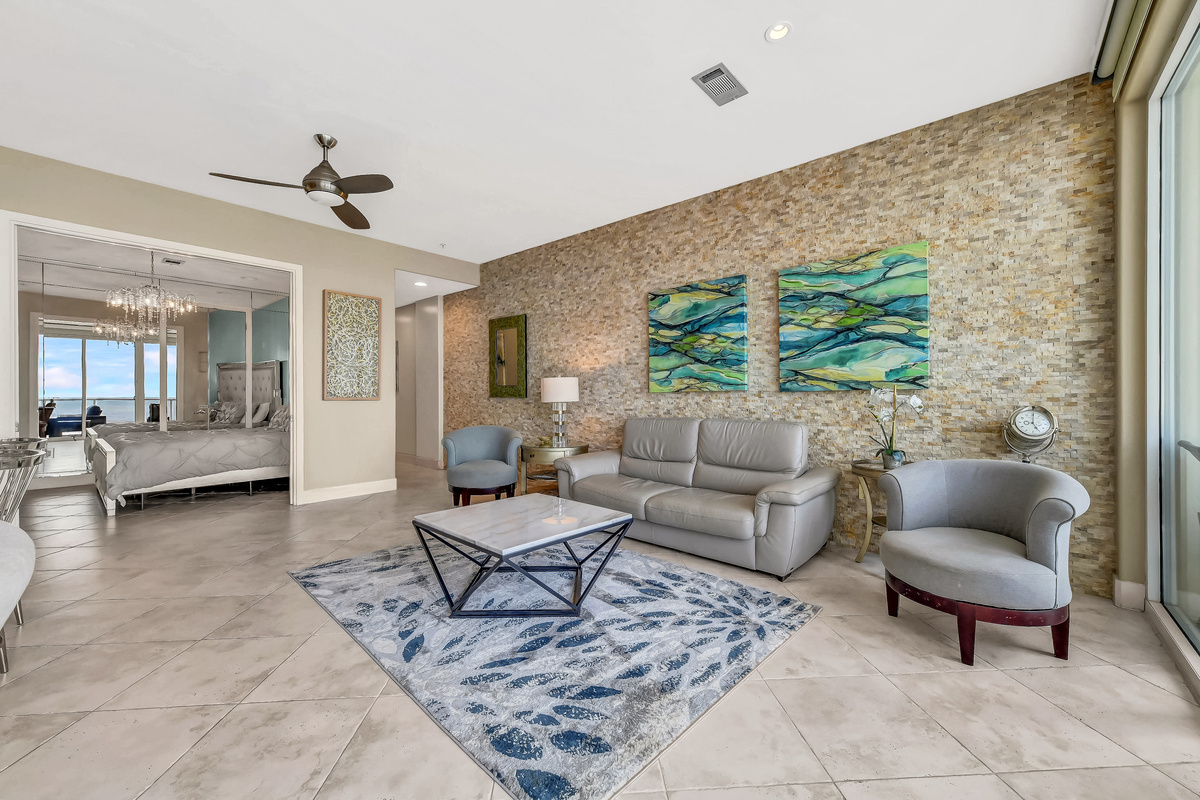 Large living with 200 sq ft with a view looking down the beach!  Coffee table and swivel arm chairs.  Plenty of room for everyone!