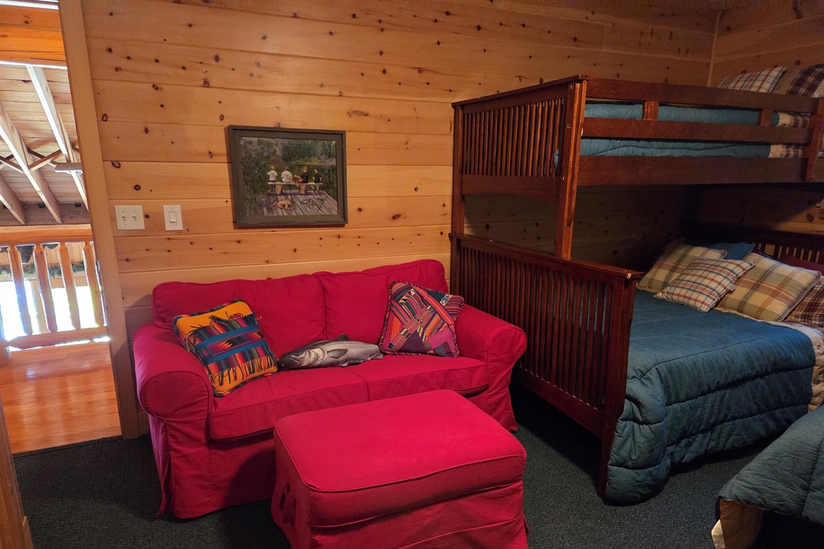 The fishing themed upstair bunkroom has 3 twin size beds, a full size bed, couch, two closets, a tv and access to the upstairs hallway bathroom.