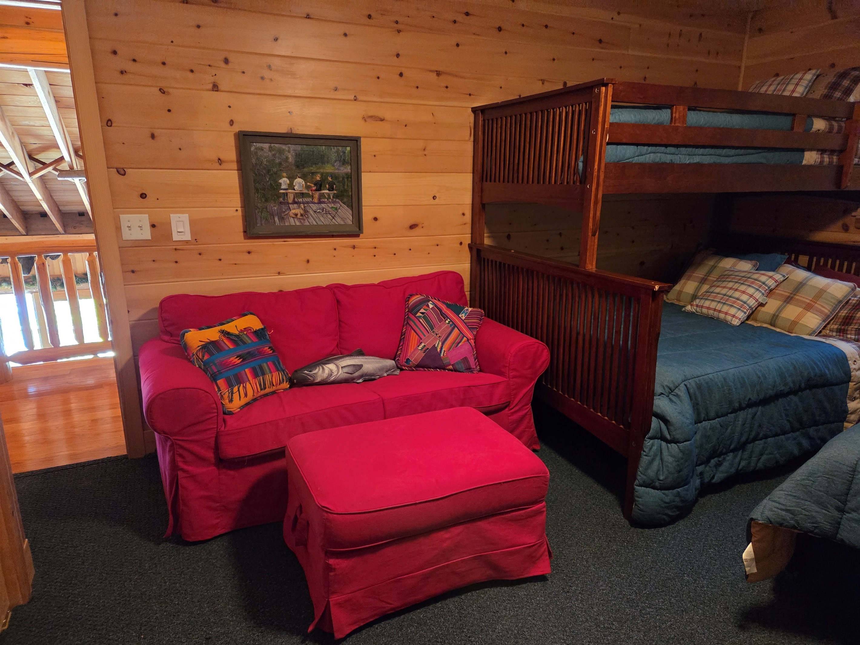 The fishing themed upstair bunkroom has 3 twin size beds, a full size bed, couch, two closets, a tv and access to the upstairs hallway bathroom.