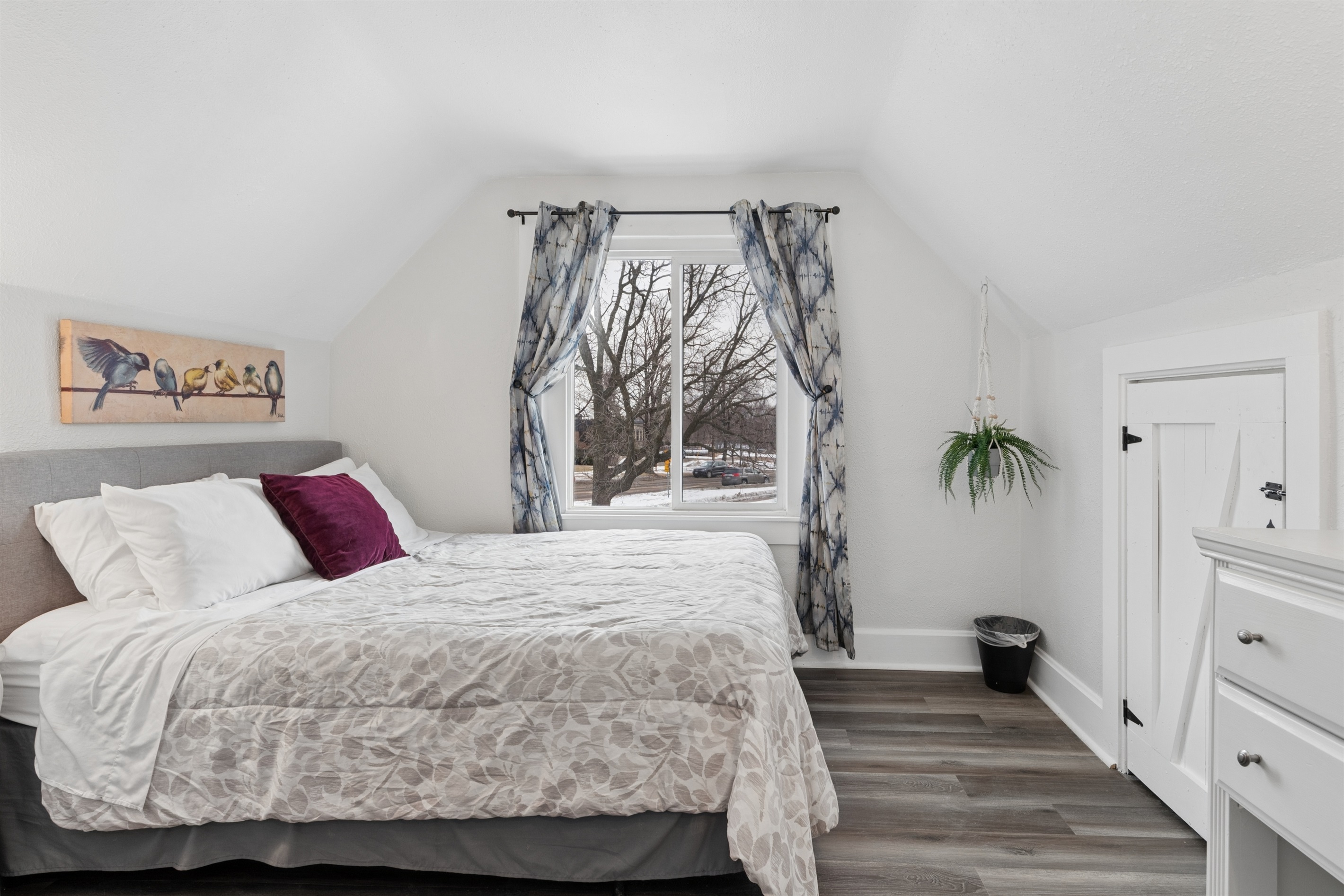 The upstairs queen bedroom overlooks the quiet cul-de-sac.