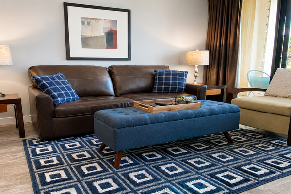 Comfortable living room with smart TV, queen sleeper sofa and balcony access.