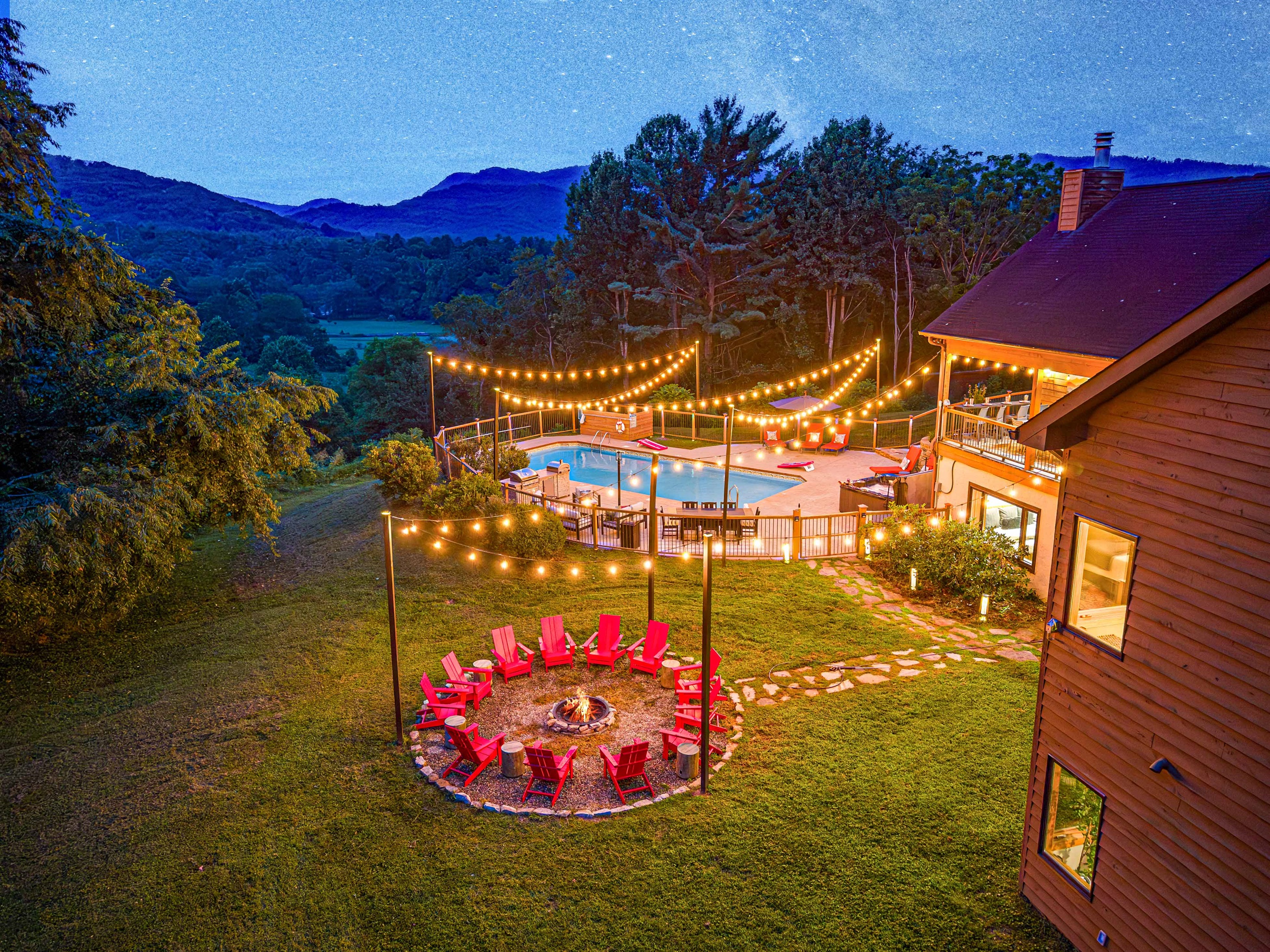 An unforgettable retreat—string lights twinkle over the pool and fire pit as the mountains fade into night, creating the perfect backdrop for laughter, connection, and memories under the stars.🌌✨