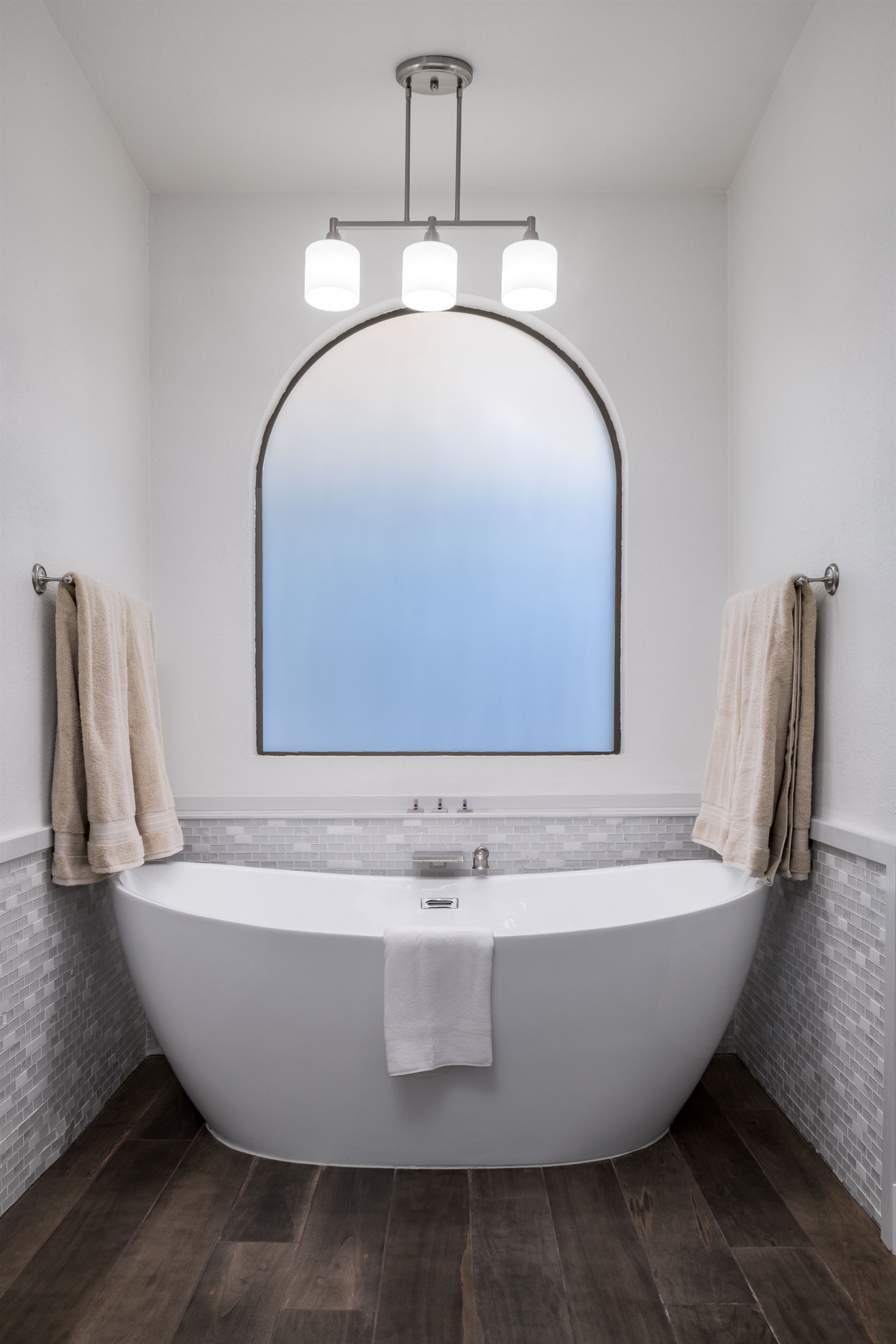 Treat yourself to spa-like luxury with a freestanding soaking tub, double vanities, and a serene modern design made for relaxation.