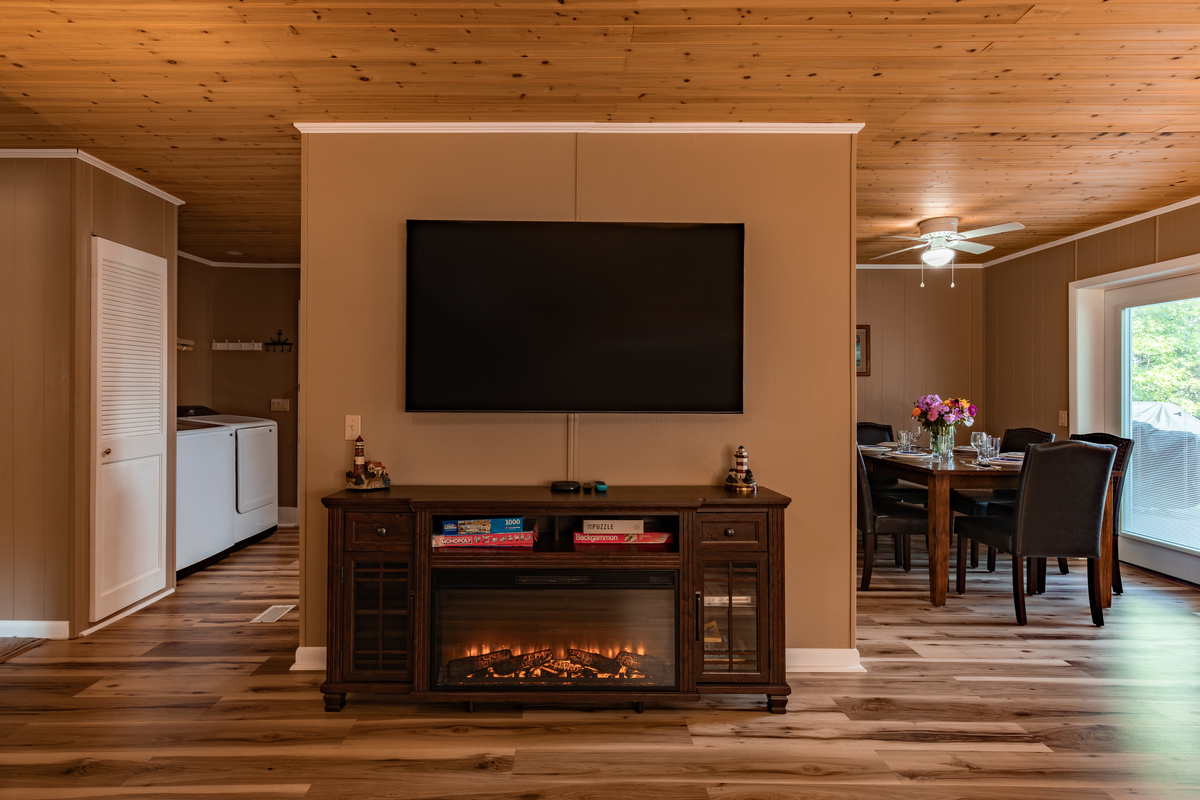 Movie night is ready with a large Roku TV and cozy electric fireplace for relaxing evenings at home.