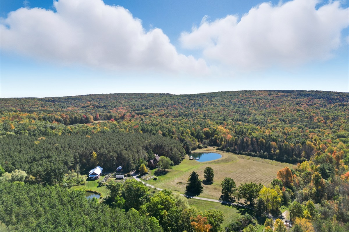 Escape to your own private retreat surrounded by rolling hills and forest. This stunning property features a spring-fed pond with a dock, wide-open meadows, and total privacy—perfect for relax