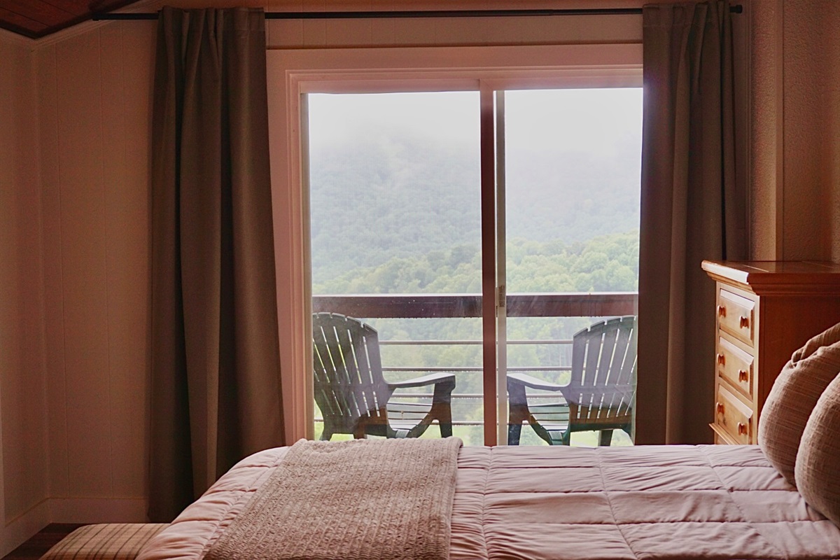 Unwind and escape. This bedroom offers a tranquil retreat with breathtaking views and private balcony access.