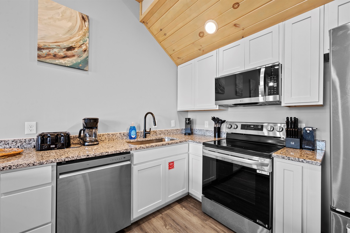 Fully equipped kitchen with stainless steel appliances, granite countertops, and all the essentials for preparing family meals, snacks, or quick breakfasts before heading out for the day.

