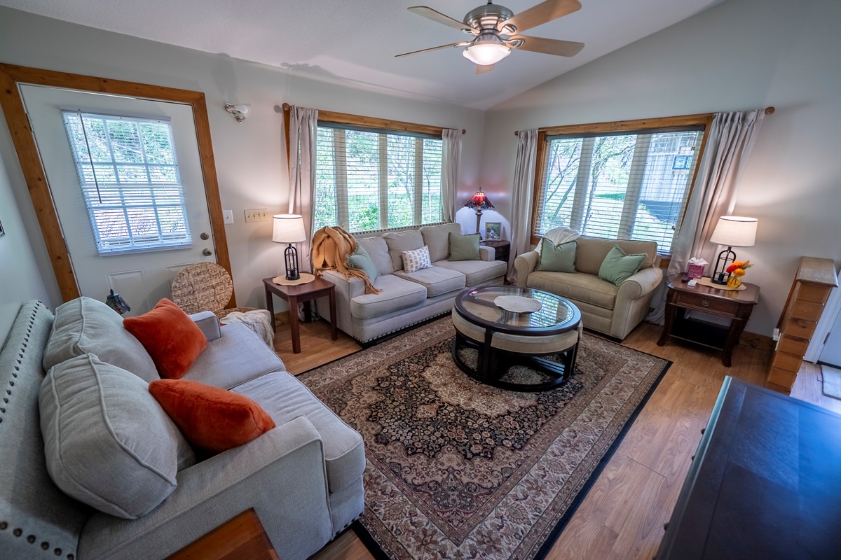 Spacious living area with flexible seating, including a convertible chair that turns into a twin bed, perfect for extra guests.