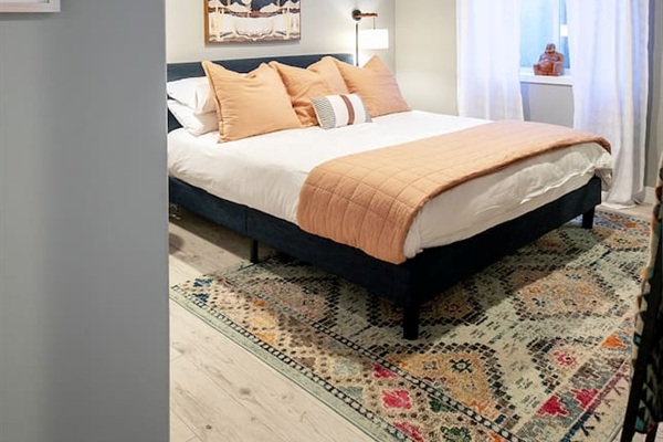 Comfortable king bedroom with modern finishes and calming tones, perfect for relaxing after a fun-filled day outside adventuring.