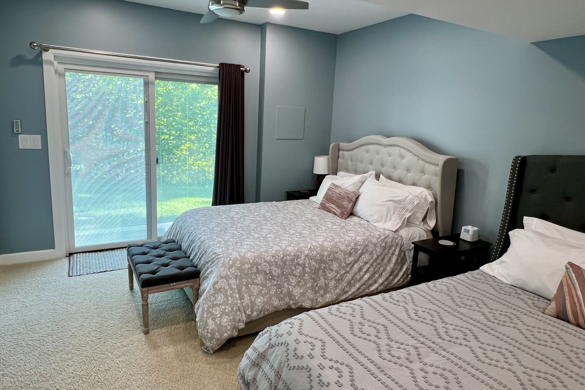There are sliding glass doors that go out to the backyard. Blinds are built into the doors, and there are blackout curtains to ensure a restful night. 