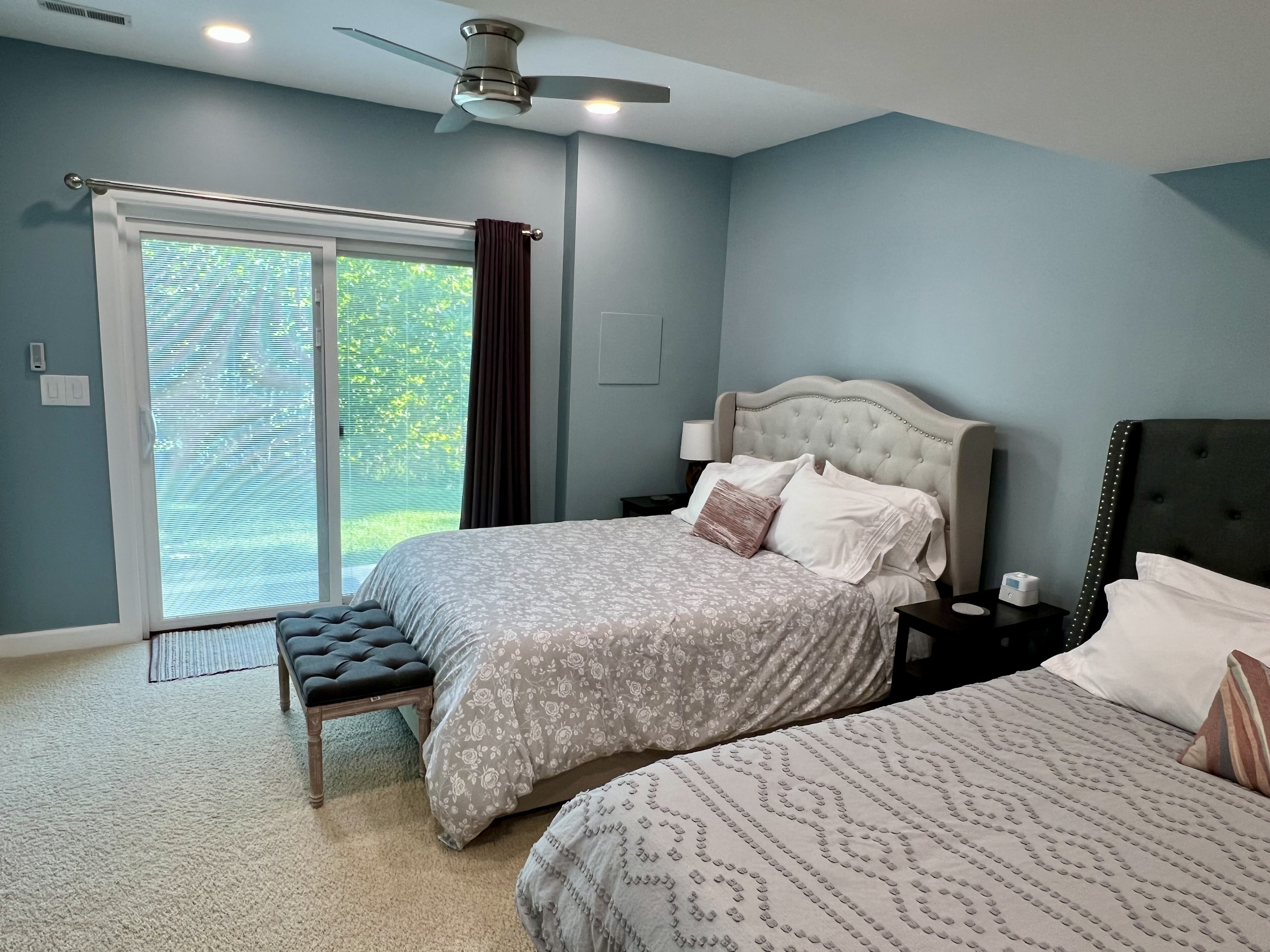 There are sliding glass doors that go out to the backyard. Blinds are built into the doors, and there are blackout curtains to ensure a restful night. 