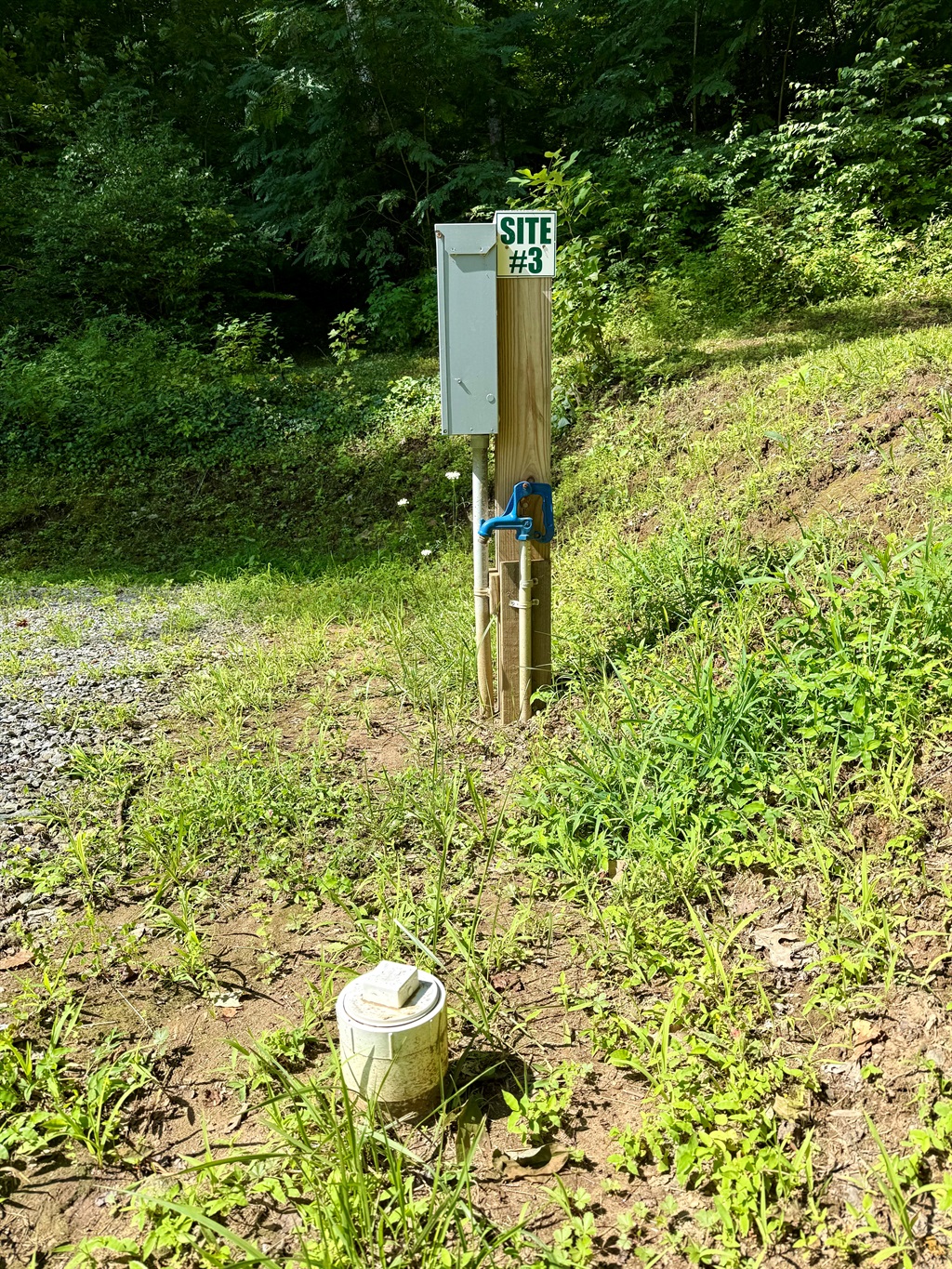 Pull in, plug in, and relax! Site 3 has 50-amp service, water & sewer, plus a picnic table for outdoor meals.