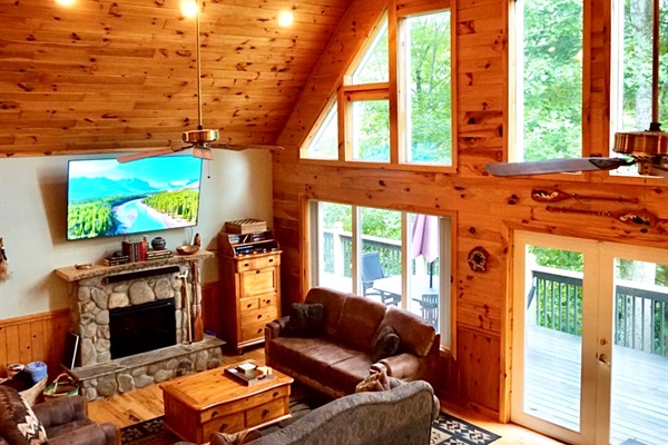 Living Room: Experience nature's beauty through expansive windows in this inviting retreat!