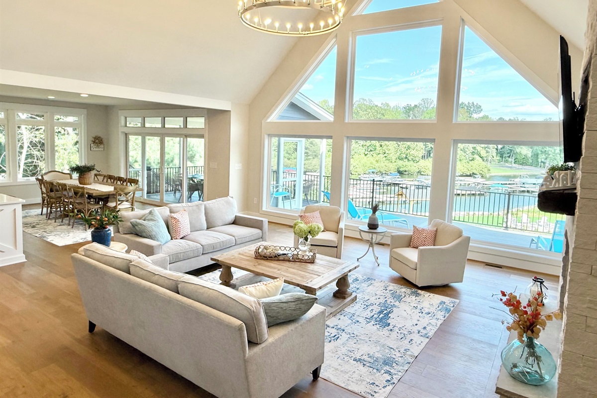 The heart of Blueberry Bay is our great room where an entire two level wall of windows shines panoramic views of the lake and floods this South facing house with natural light all day! The sunrises are stunning also and not to be missed-our favorite!