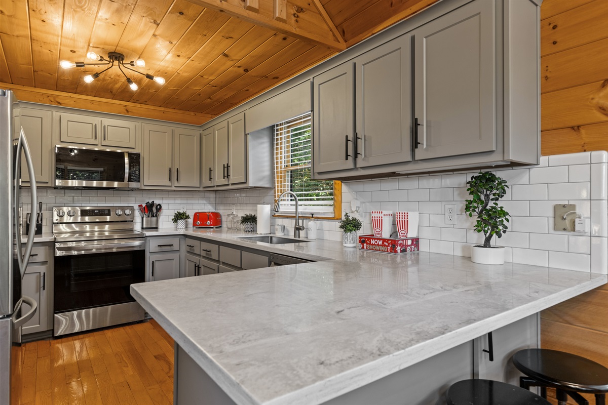 Step into the cream-toned kitchen... fully stocked, beautifully designed, and ready for feasts.