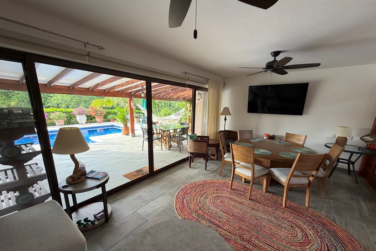 Family/TV room with view to the pool and patio beyond