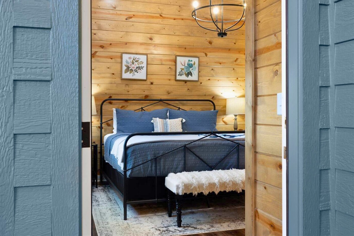 Restful nights are promised in this king bed, ensconced in woodland serenity