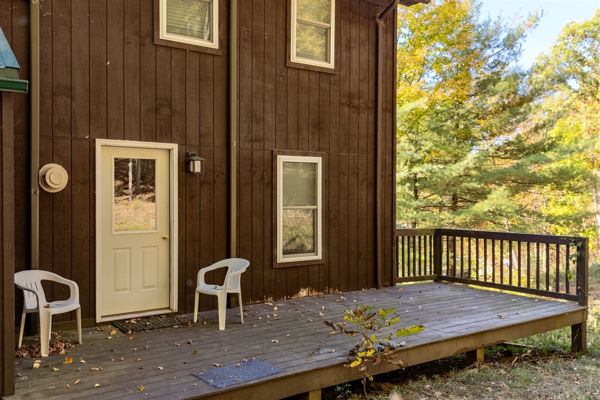 Entry door view plus two chairs on the porch — inviting and relaxed.