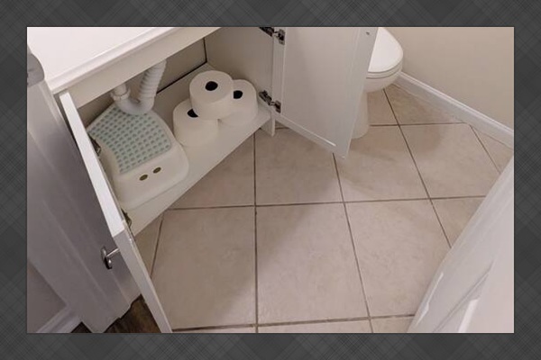 Half bath has plenty of toilet paper, hand soap, fresh towels, and a step stool for children. 