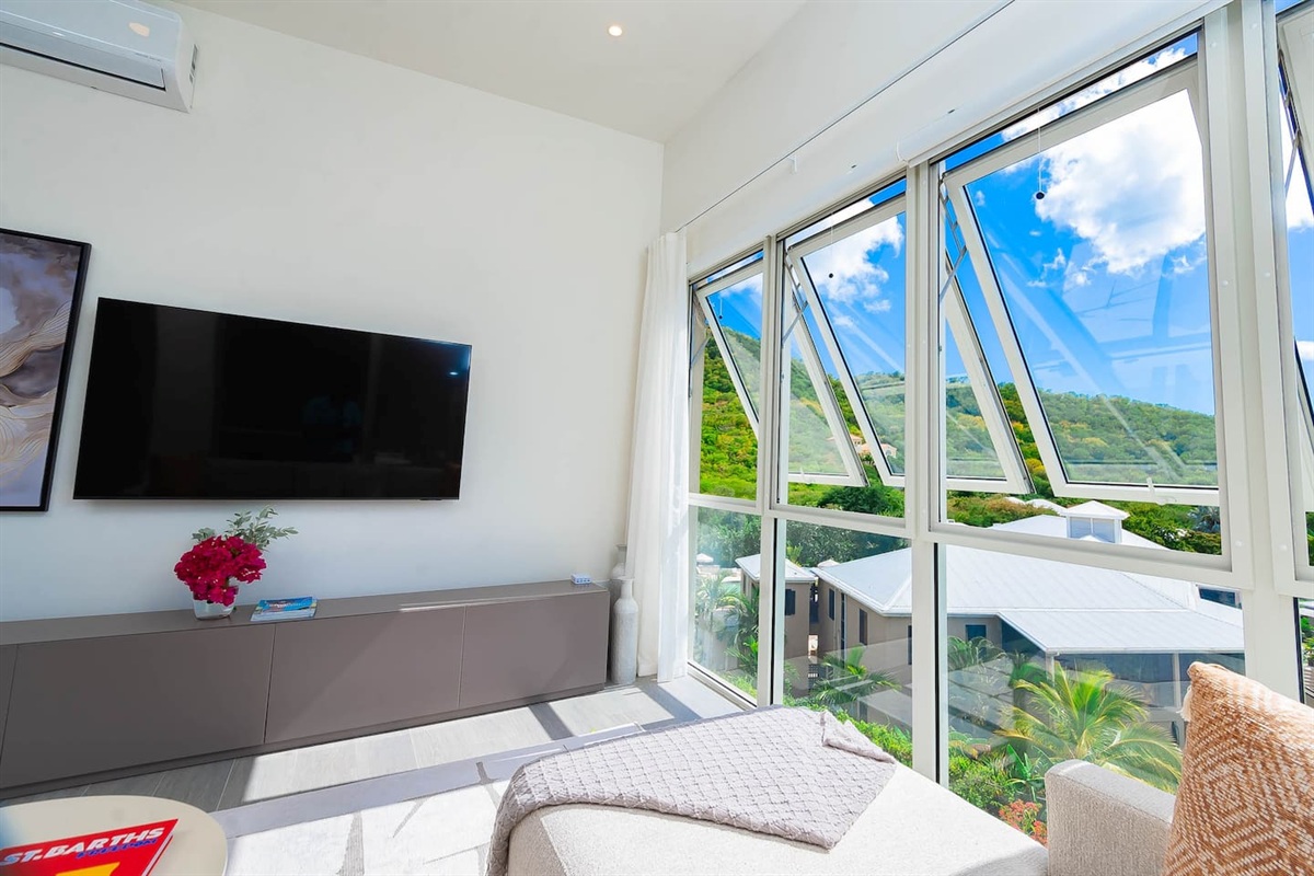 Living room with amazing views of the hillside and ocean.