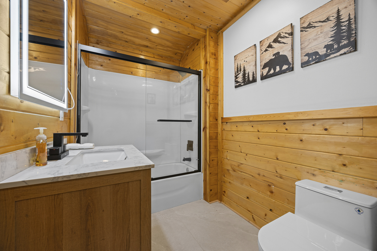 Bathroom Retreat: Enjoy modern elegance with rustic charm, featuring a sleek shower and cozy decor!